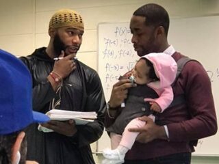 Leraar past tijdens les op baby, omdat de student geen oppas kon regelen