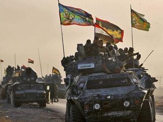 'Ik zie een bont gezelschap strijders aan de rand van Mosul'