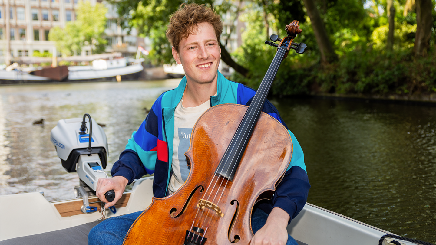 Kalle de Bie met zijn cello in een boot