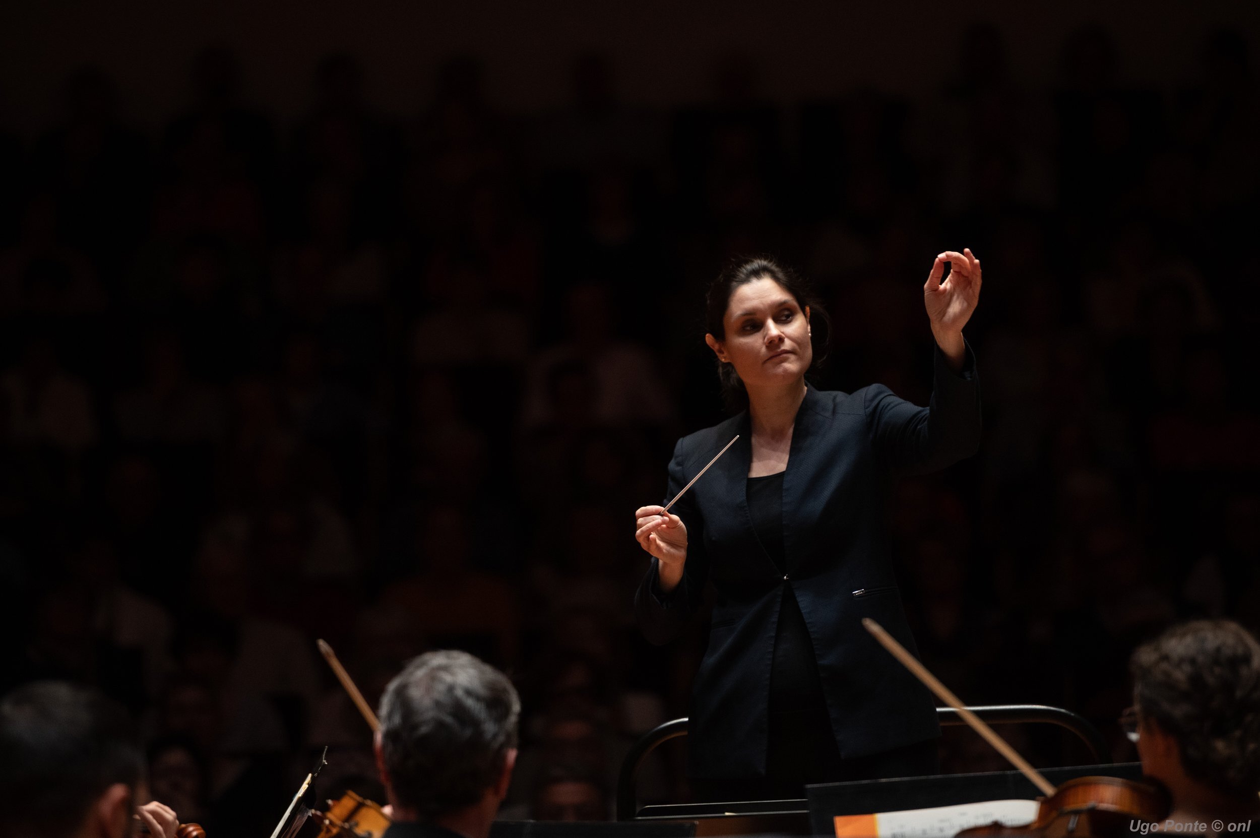 Dirigent Delyana Lazarova staat voor het orkest en dirigeert